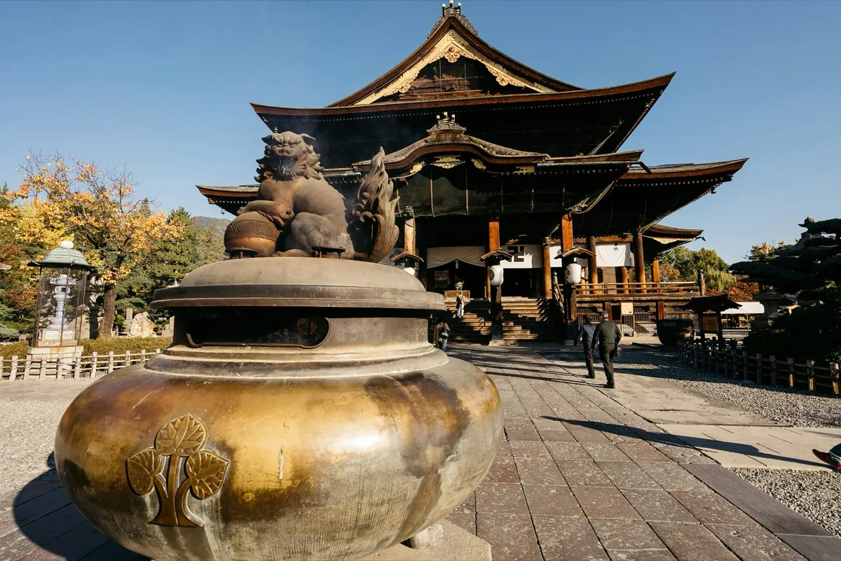 Wooden main hall of Nagano's Zenko-ji temple with its bronze incense burner