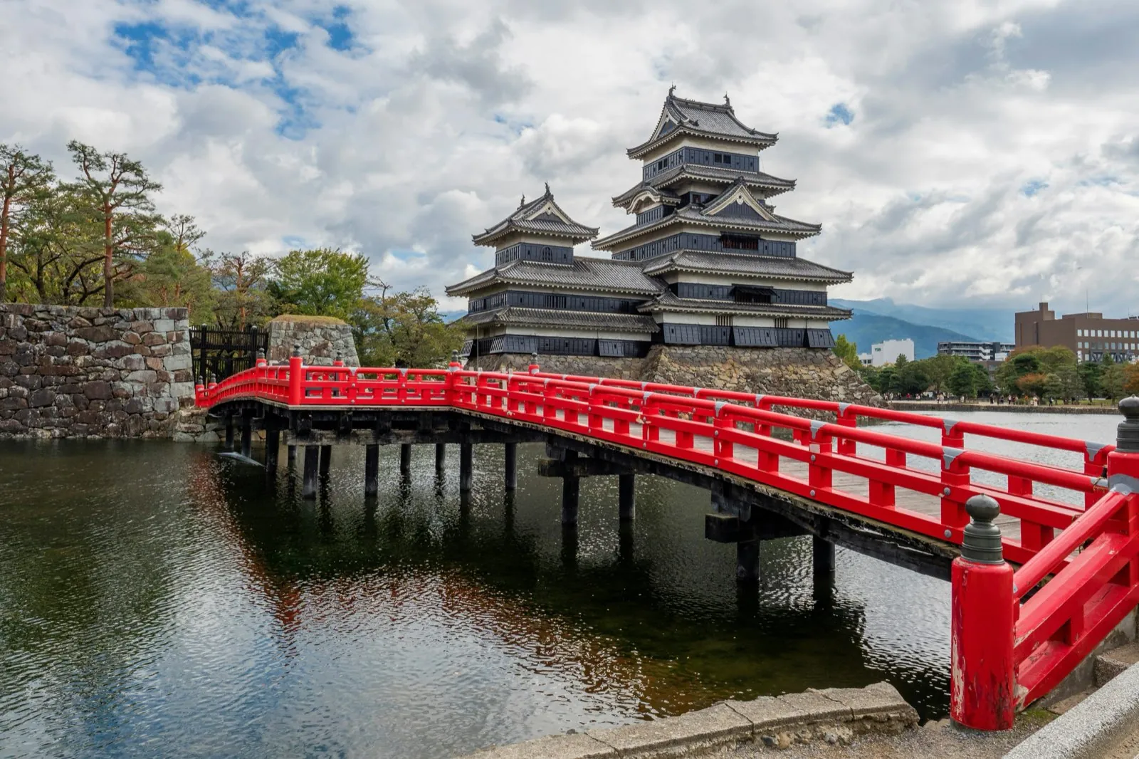 Matsumoto Castle with its black keep and the red bridge over the moat, in Nagano prefecture