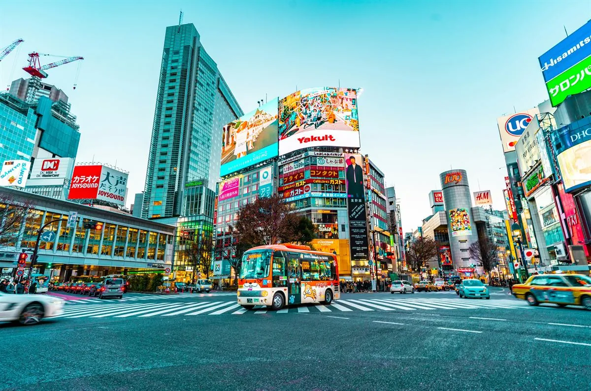 Shibuya pedestrian crossing and the lights of Shinjuku in Tokyo